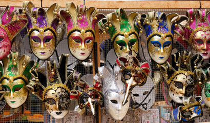 Traditional venetian masks on shelves in souvenirs shop in Venice, Italy. 