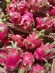 Dragon fruit pitaya pitahaya in wicker baskets in a supermarket....