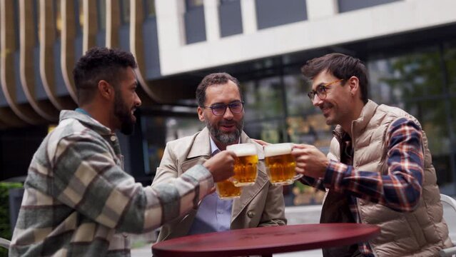 Best friends togehter, drinking beer and talking in bar in city. Concept of male friendship, bromance.