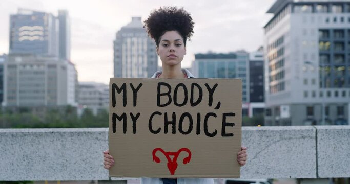 Woman, poster and protest in city for empowerment, human rights or pro abortion on bridge in an urban town. Portrait of female person or activist with cardboard placard or sign for choice or equality