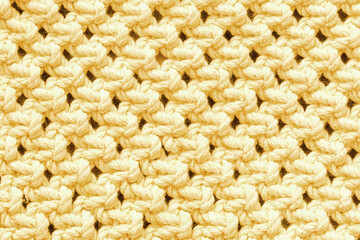 Knitwear background. Yellow woolen fabric texture. Warm jumper closeup. Yarn textile backdrop. Handmade sweater texture. Cotton pattern.