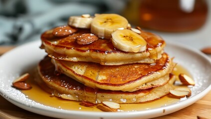 Obraz na płótnie Canvas a plate of pancakes with bananas and almonds