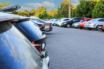 Cars in a large parking lot near the park