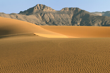 DESERT LANDSCAPE IN THE SAHARA DESERT IN ALGERIA WITH SAND DUNES AND SAND PATTERNS. 