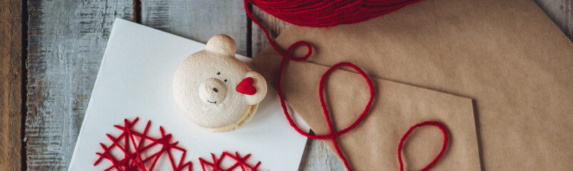 Simple romantic surprise for a Saint Valentine's Day morning. Wooden letter with phrase I love you on craft envelope with love message. Happy relationships. Sweet homemade cookie banner