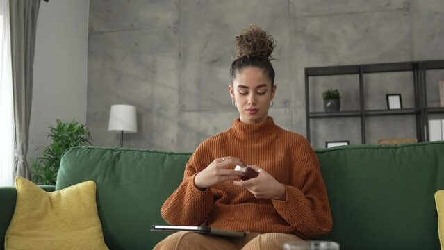 woman hold medicine drugs vitamin supplement bottle pills read label