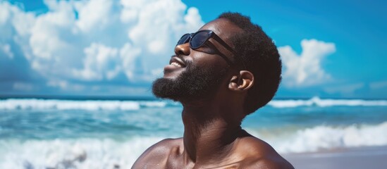 Black-skinned man enjoying fresh air at the beach.