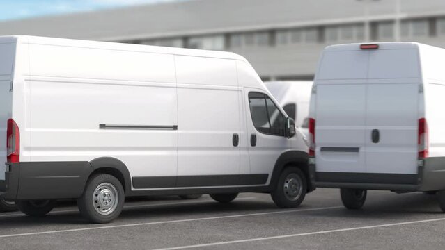Express delivery, logistic and shipping service concept. Delivery vans in a row on a parking near warehouse.