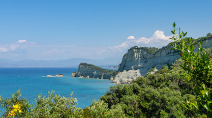 Naklejka premium Cape Drastis cliffs near Sidari and Peroulades on Corfu island in Greece. Famous rock formations with small beach and rugged coastline. Popular Greek destination for summer vacation