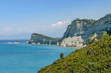 Fototapeta premium Cape Drastis cliffs near Sidari and Peroulades on Corfu island in Greece. Famous rock formations with small beach and rugged coastline. Popular Greek destination for summer vacation