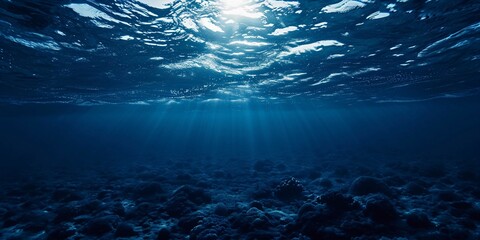 Fototapeta na wymiar Dark blue ocean surface seen from underwater, horizontal wide background.
