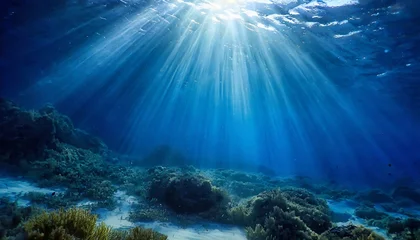 Fotobehang abstract image of tropical underwater dark blue deep ocean wide nature background with rays of sunlight © Trevin