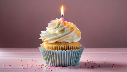 mouthwatering birthday cupcake steals the spotlight topped with creamy frosting and a single burning candle ready to be blown out and make a wish on pink background - obrazy, fototapety, plakaty