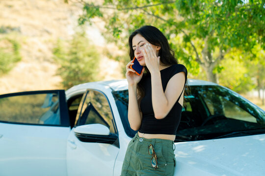 Young Woman calling others with repairing the car