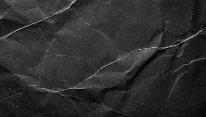 Deurstickers crumpled black paper with a detailed texture close up the paper with white cracks rough paper texture for background © Marcelo