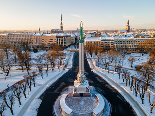 Beautiful sunrise view in Riga Latvia by the statue of liberty - Milda.