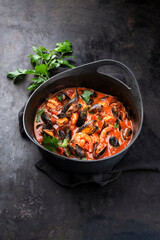 Traditional Creole cajun court bouillon with mussels and prawn gumbo chowder stew as close-up in a pot