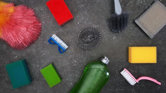 Cleaning. Stop motion animation. Variety of items for cleaning house and kitchen. Detergent, kitchen sponges, dish brushes, microfiber cloths appear and disappear at random. Housecleaning concept.