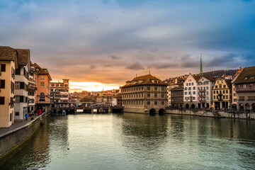 Fototapeta na wymiar Zurich city center, Switzerland. Zuerich old town with Town Hall and Rathaus bridge on bank of river Limmat at sunset with dramatic sky in winter