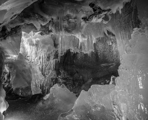 Great ice formation in a natural small glacial ice cave