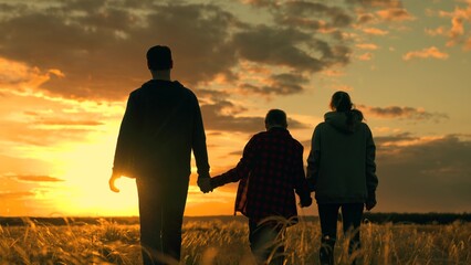 Father, mother, boy, son walk happily through meadow. Child parents dream dream. Happy family team,...
