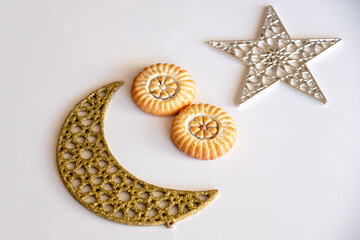 Variety of semolina maamoul cookies displayed with crescent ,star and Ramadan decorations. Traditional Arabic sweets for Eid al Adha and Eid al Fitr celebrations.
