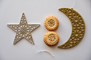 Variety of semolina maamoul cookies displayed with crescent ,star and Ramadan decorations. Traditional Arabic sweets for Eid al Adha and Eid al Fitr celebrations.