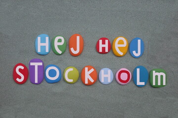 Hej Hej Stockholm, creative logo composed with hand painted multi colored stone letters over green sand - obrazy, fototapety, plakaty