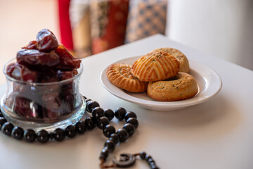 Variety of semolina maamoul cookies displayed with crescent ,star and Ramadan decorations. Traditional Arabic sweets for Eid al Adha and Eid al Fitr celebrations.