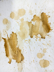 Abstract brown coffee grunge background. Brown coffee stains on white paper. Coffee drops on paper. Dirty paper.