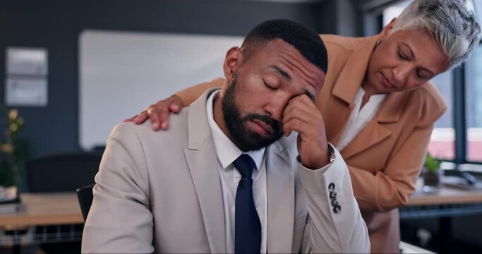 Business people, man and sad with comfort in office for lost financial investment with kindness at job. Woman, person and staff with support, empathy and fired for mistake, fail or crisis at agency