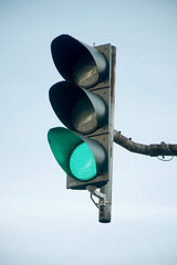 green traffic light on blue sky
