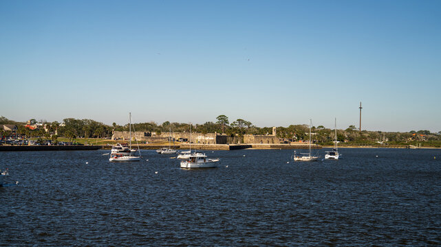 Sailboats anchored in the Matanzas River with a clear blue sky in St Augustine, FL.