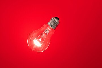 light bulb floating on red background