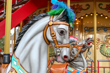 Fototapeta na wymiar Horse carousel ride. Carnival Ride. A horse in an amusement park for children. Horse on the merry-go-round. Entertainment for youth.
