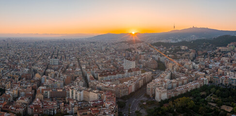 Fototapeta na wymiar Aerial view of Barcelona City Skyline at sunset. Residential famous urban grid of Catalonia. Beautiful panorama of Barcelona.