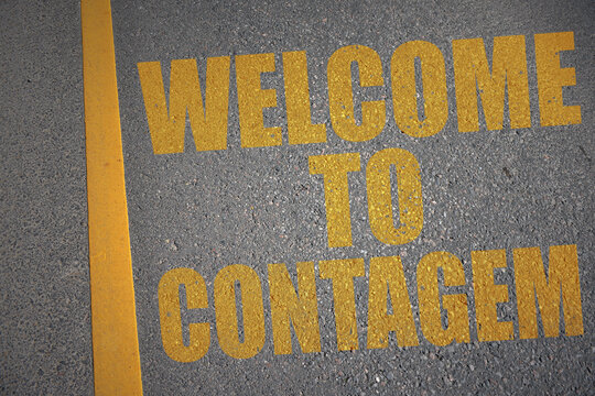 asphalt road with text welcome to contagem near yellow line.