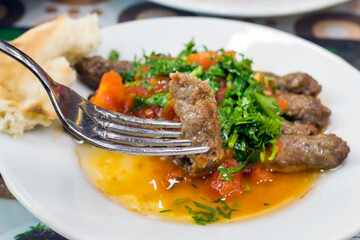 Tire meatballs, which are peculiar to the Tire district of İzmir, Turkey, are grilled with a thickness of a pen on thin skewers.