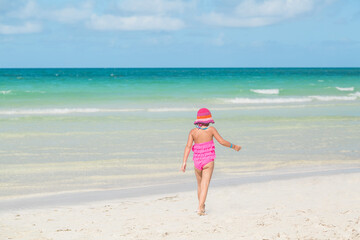 little girl walking on the beach