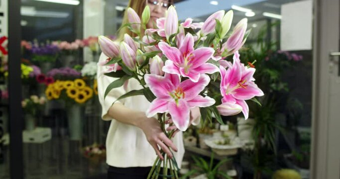 the florist is showing some lilies that have bloomed