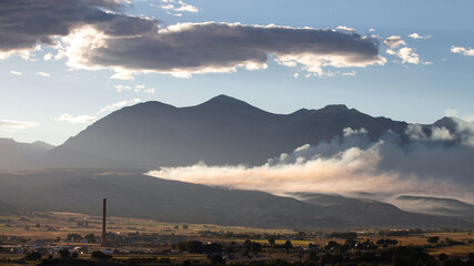 Landscape view of smoke drifting at sunset from control burn in Salida Colorado United States
