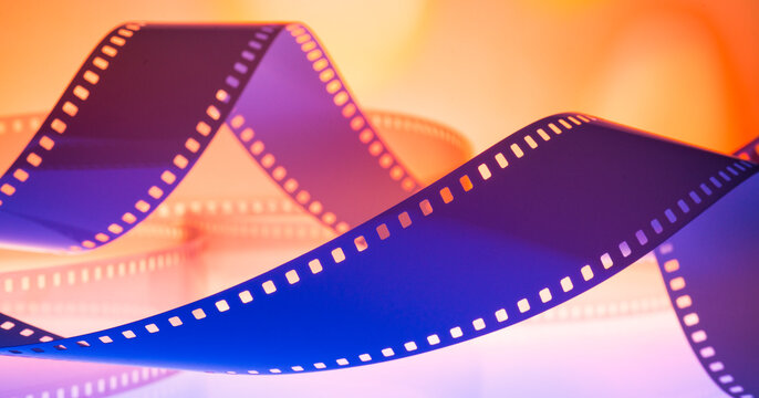 abstract multicolored background with film strip.film festival film production premiere announcement concept