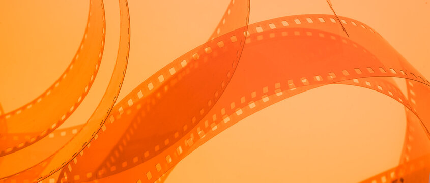 abstract multicolored background with film strip.film festival film production premiere announcement concept - Powered by Adobe