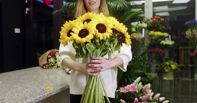  Florist in a flower store shows sunflowers