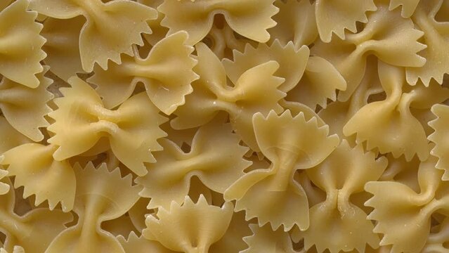 Italian farfalle pasta background. Table spin.