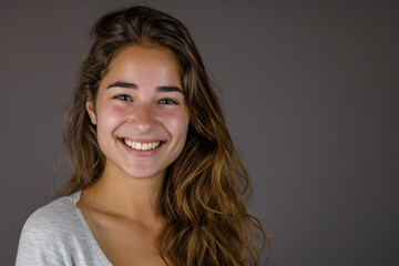 Fototapeta premium A woman with long hair is smiling for the camera