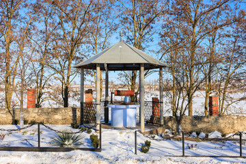 Well in a winter village. Background with selective focus and copy space