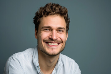 Fototapeta premium A man with a beard is smiling for the camera