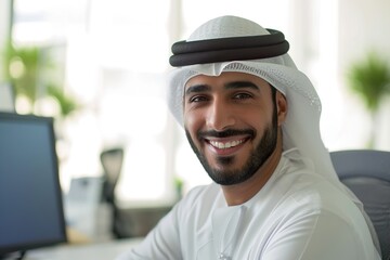 smiling emirati arab at office wearing kandura