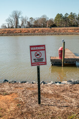 No fishing sign on the beach of Lake Wylie in South Carolina.